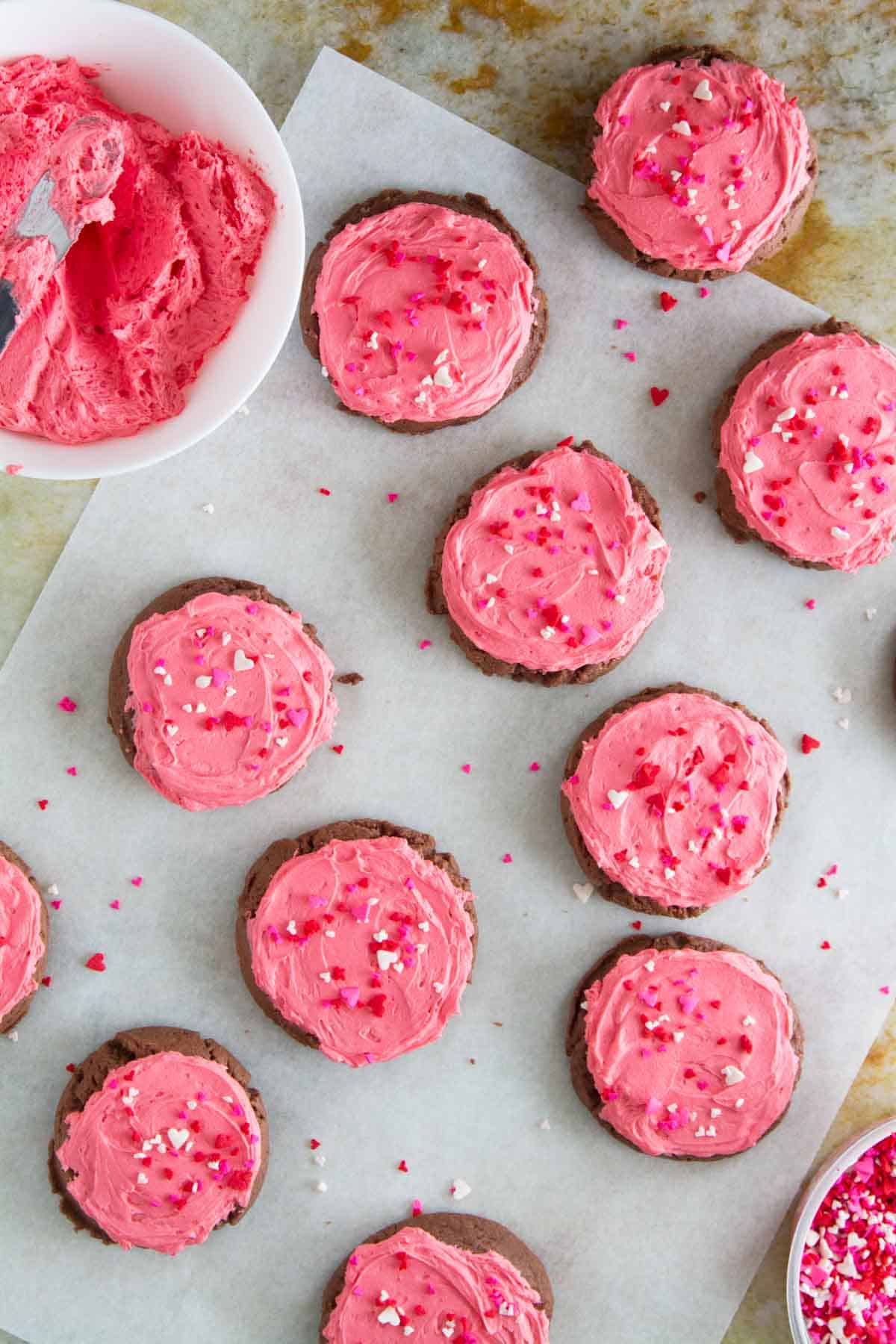 overhead view of chocolate sugar cookies with buttercream frosting and sprinkles