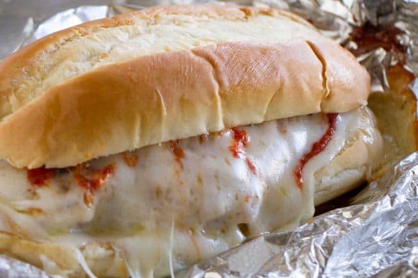 Chicken Parmesan goes sandwich style in these easy and portable Oven Baked Chicken Parmesan Sandwiches. Breaded chicken is topped with marinara, cheese and basil, layered on a roll, then baked in a foil packet.
