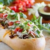 Taco Tuesday looks a little different with this Taco French Bread Pizza taking center stage! All of your favorite taco flavors are nested in a loaf of French bread for a dinner the whole family loves.