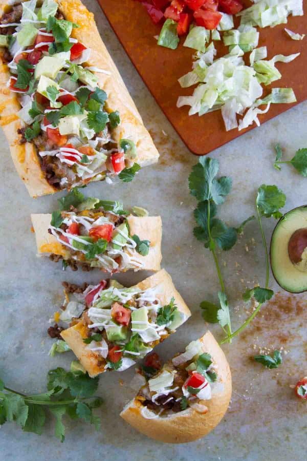 Taco Tuesday looks a little different with this Taco French Bread Pizza taking center stage! All of your favorite taco flavors are nested in a loaf of French bread for a dinner the whole family loves.