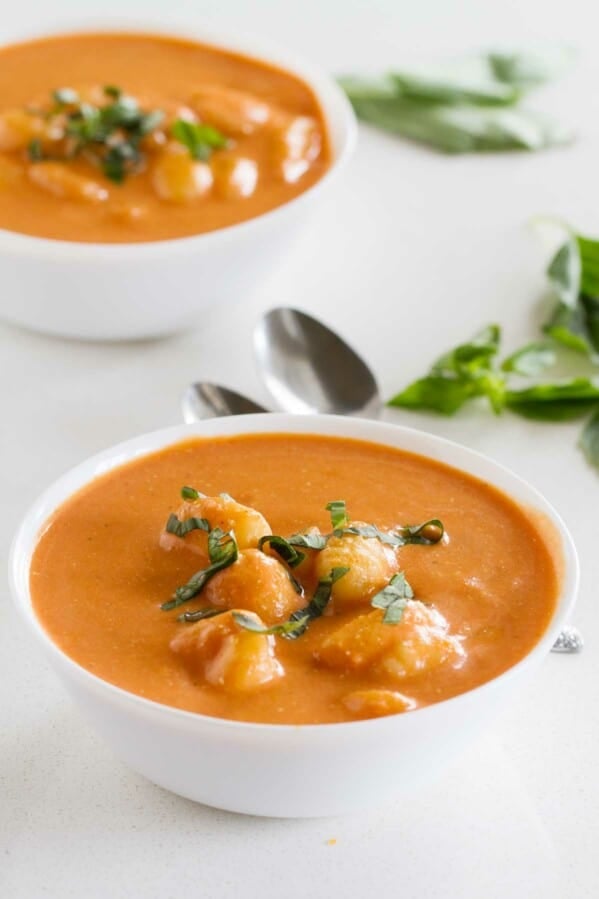 Two bowls filled with Creamy Slow Cooker Tomato Soup with Gnocchi.