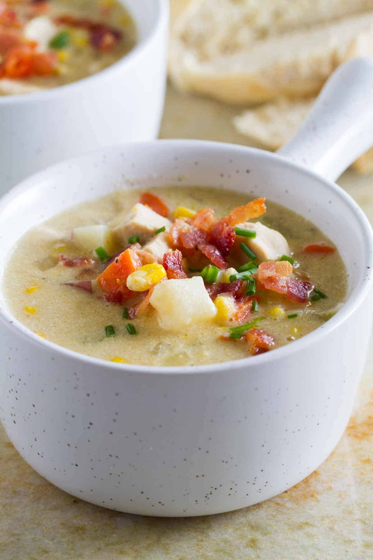 Small bowl of chicken corn chowder with potatoes, bacon, and corn.