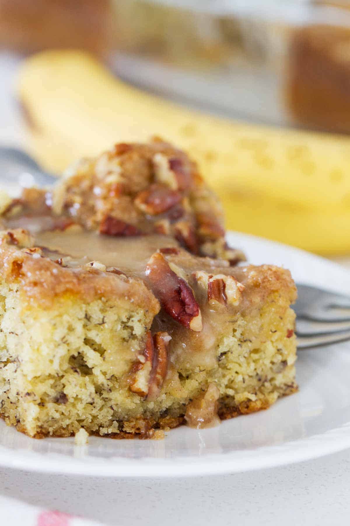 slice of banana coffee cake with honey glaze and pecans