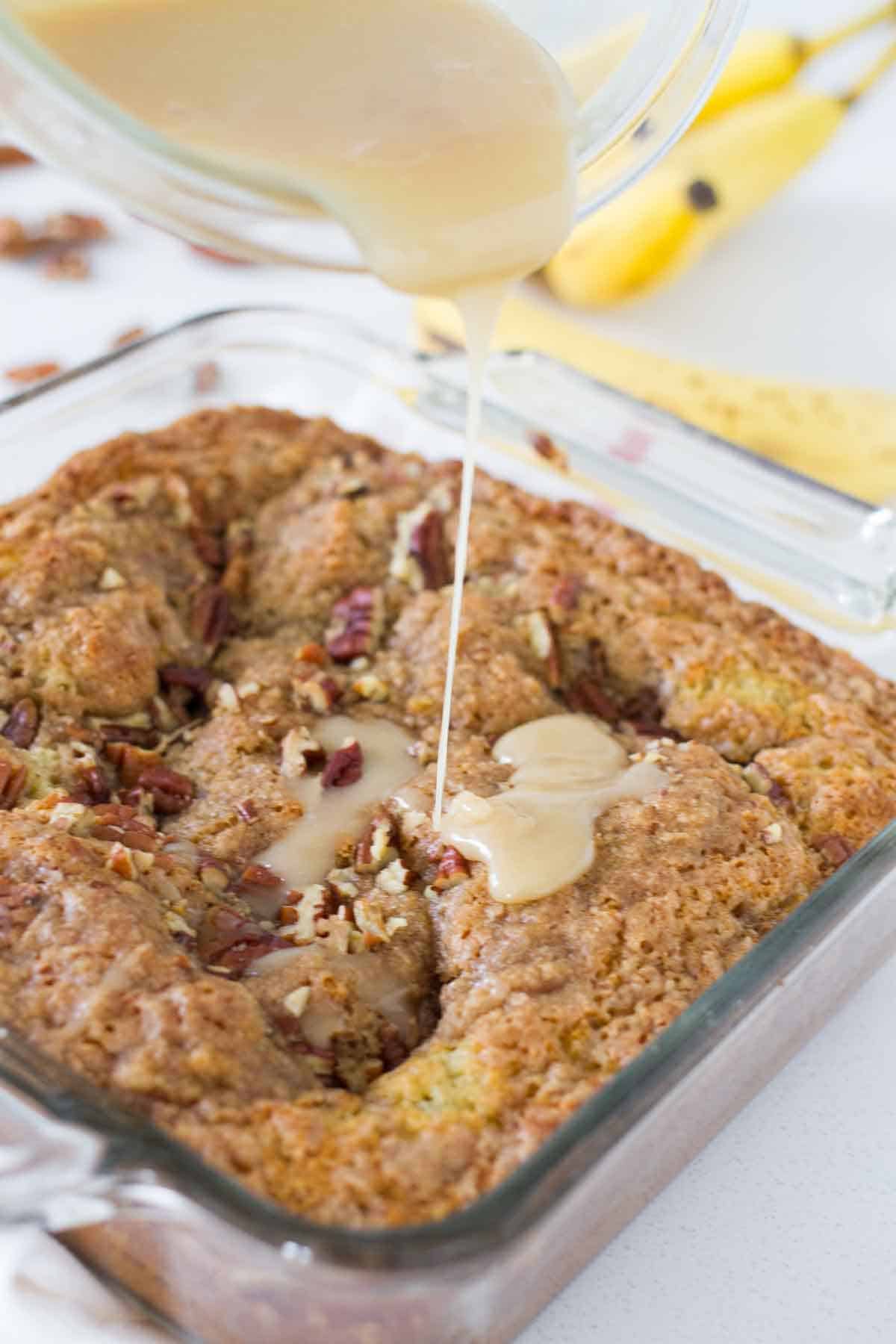 pouring glaze over banana coffee cake