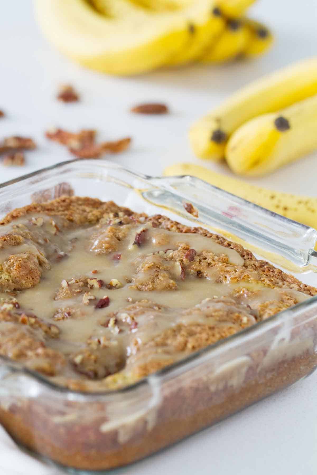 banana coffee cake with honey glaze in a baking dish