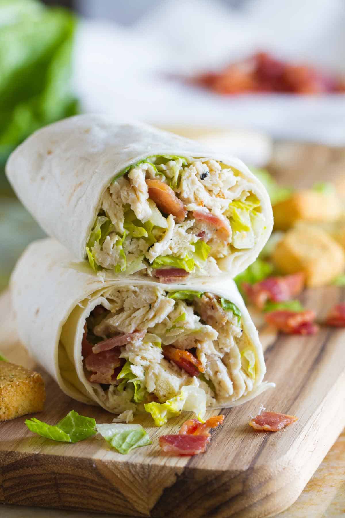 Chicken Caesar Wrap cut in half with one half stacked on top of the other.