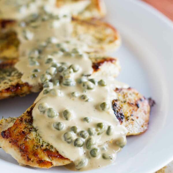 This Chicken in Caper Cream Sauce is an easy but elegant dinner recipe. Boneless chicken breasts are cooked in a skillet and served with a creamy caper cream sauce.