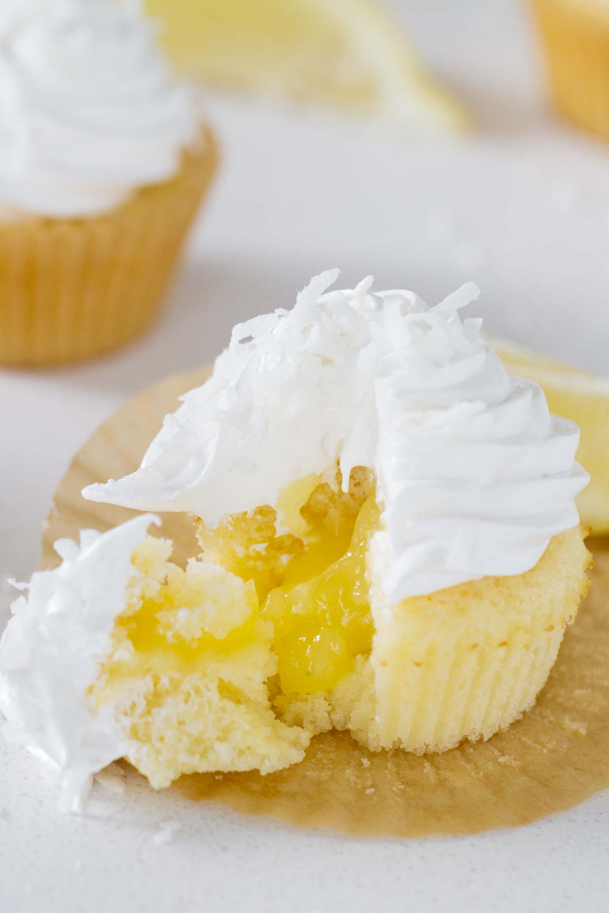 Lemon sunshine cupcake cut open to show the lemon filling in the center.