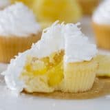 Bring in a little bit of sunshine with these Lemon Sunshine Cupcakes! Based on an old favorite cake, these cupcakes are filled with lemon curd and topped with a dreamy fluffy frosting. A sprinkling of coconut tops them off.