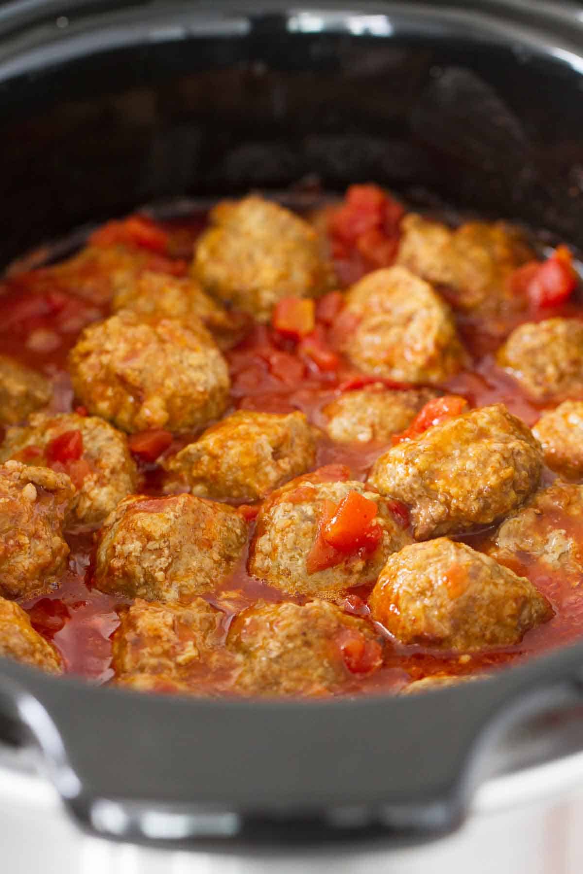 Mexican meatballs cooking in a slow cooker.