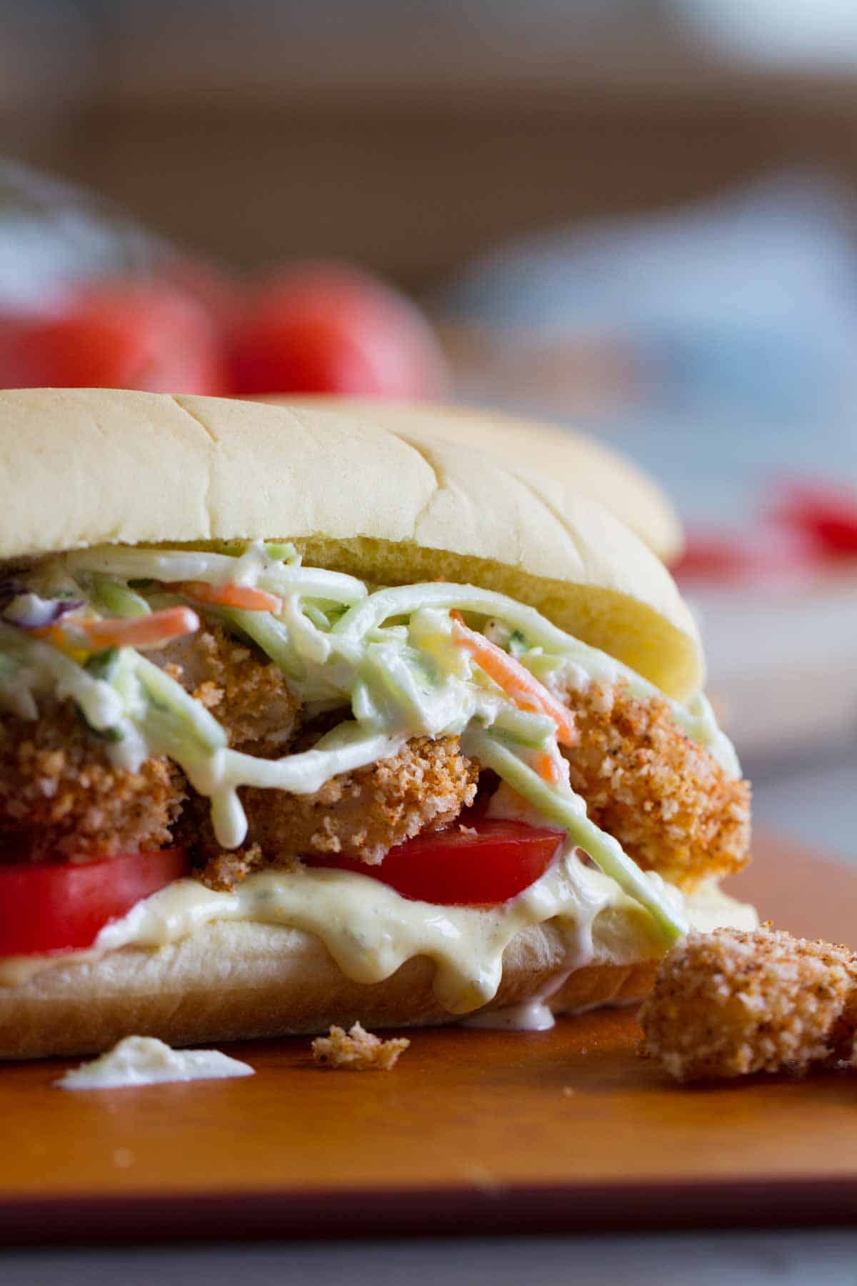 Shrimp Po Boy sandwich with creamy sauce, tomatoes, baked shrimp, and pineapple slaw.