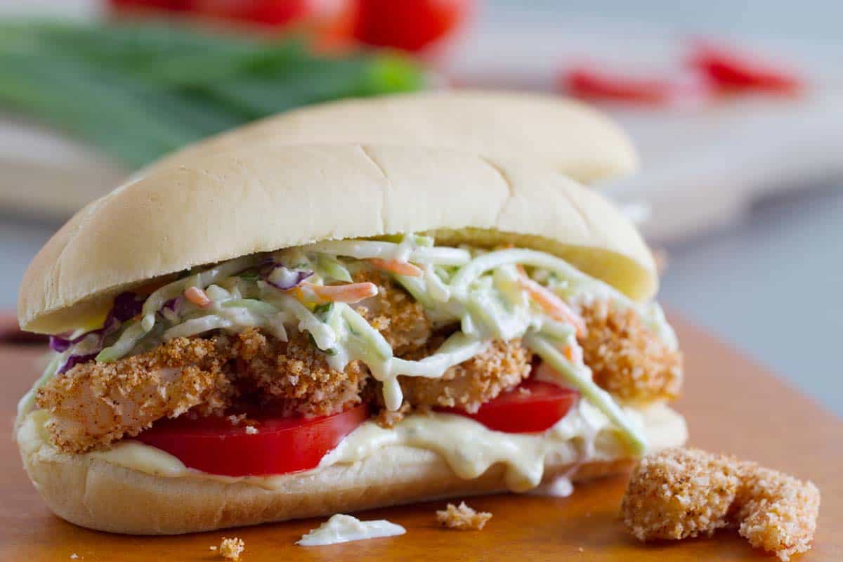 Shrimp Po Boy Sandwich with pineapple slaw and tomatoes.