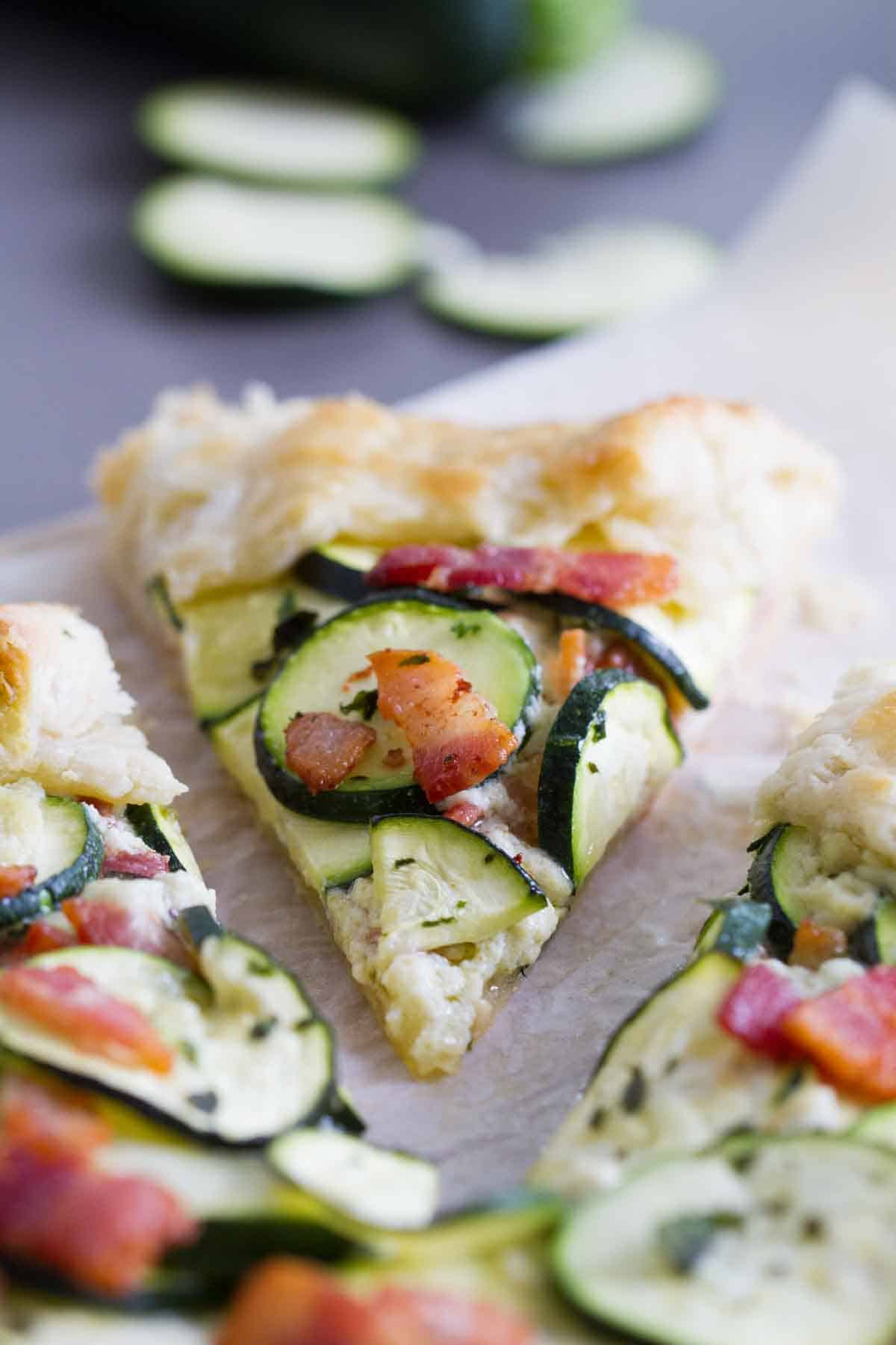 slice of zucchini tart topped with bacon