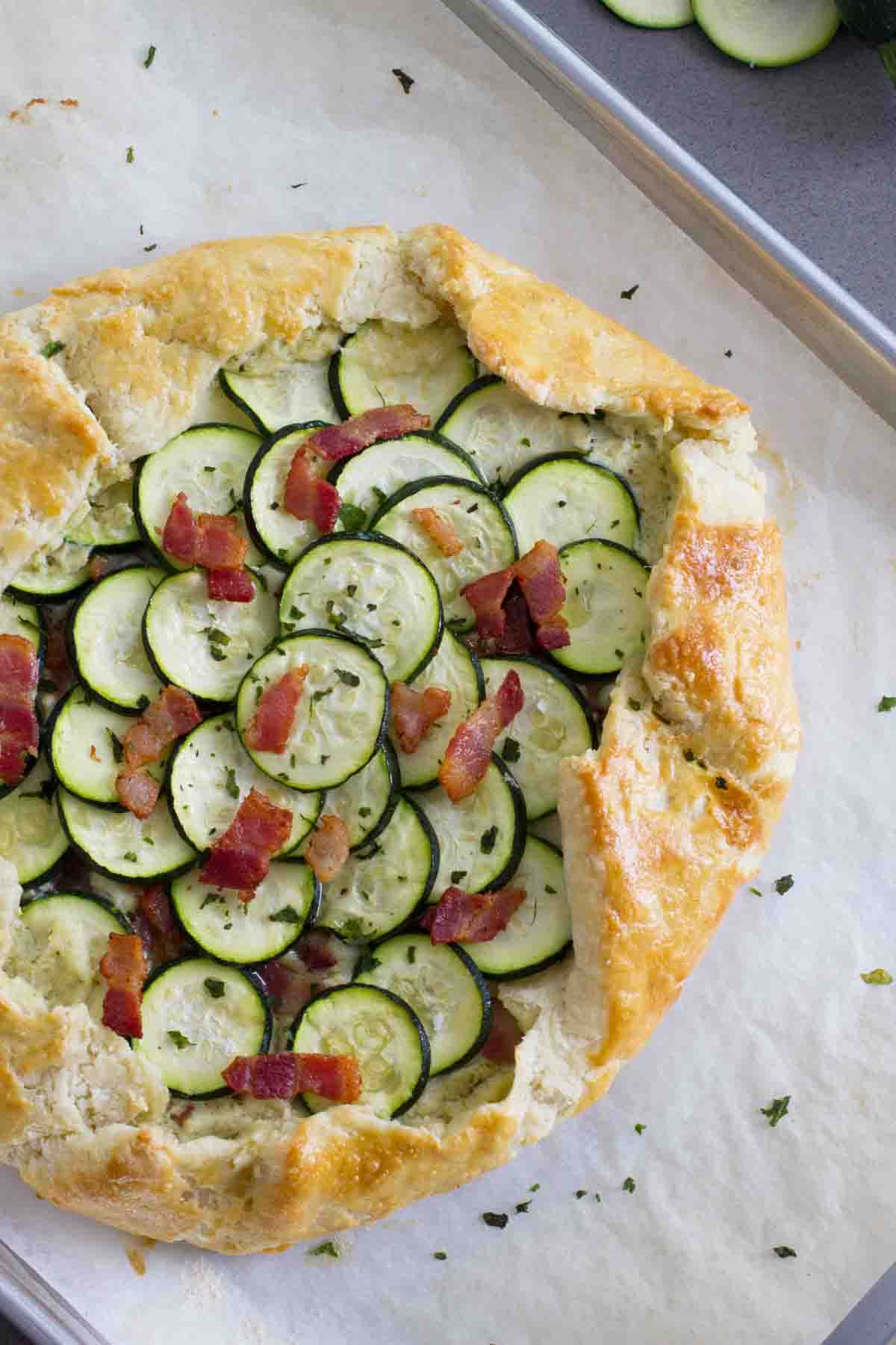 overhead view of full zucchini tart with ricotta and bacon