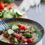 Fast, easy and full of flavor, this Spicy Pork Noodle Bowl recipe is delicious and addictive. Who needs the local noodle place when you can make these at home?