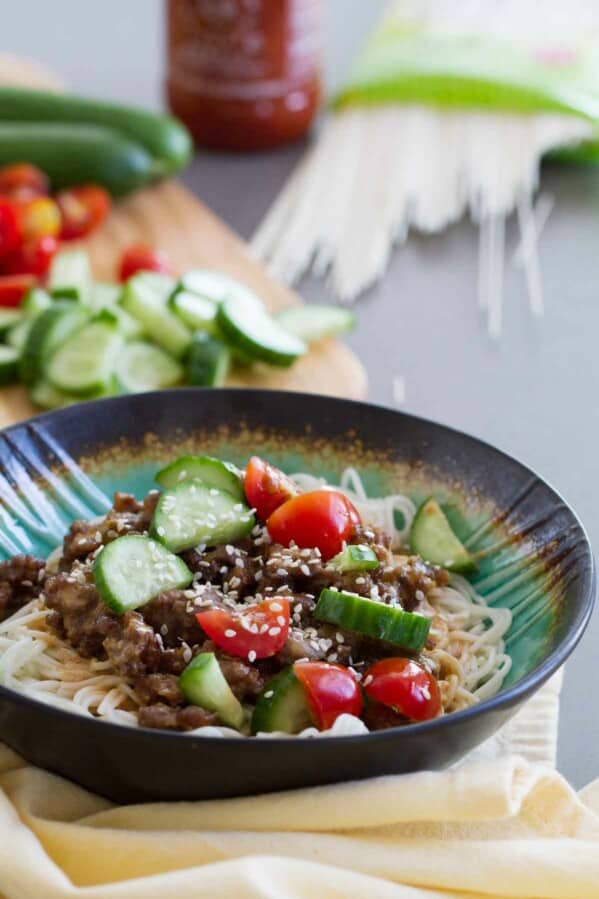 Fast, easy and full of flavor, this Spicy Pork Noodle Bowl recipe is delicious and addictive. Who needs the local noodle place when you can make these at home?