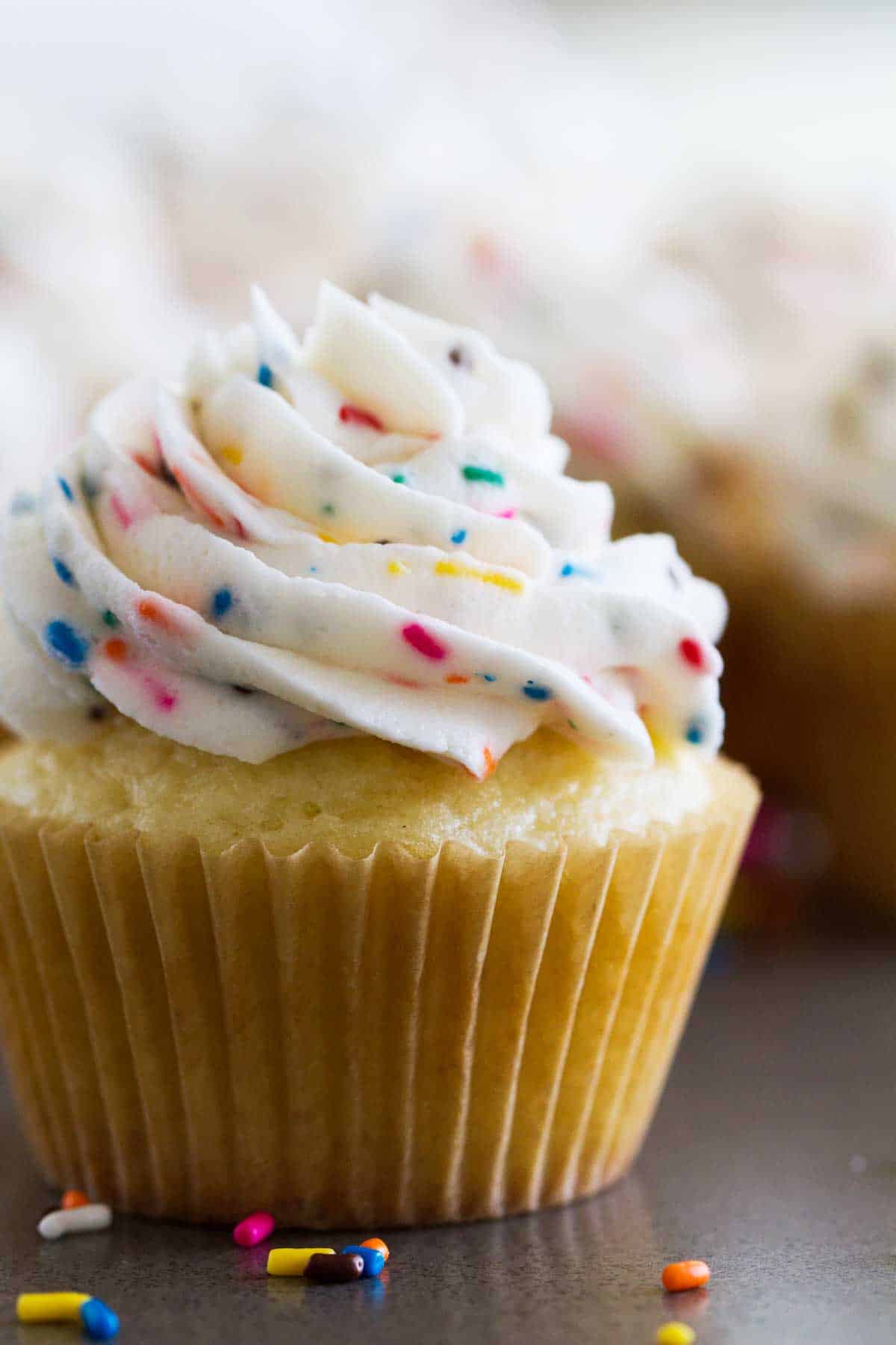 single cupcake topped with funfetti frosting