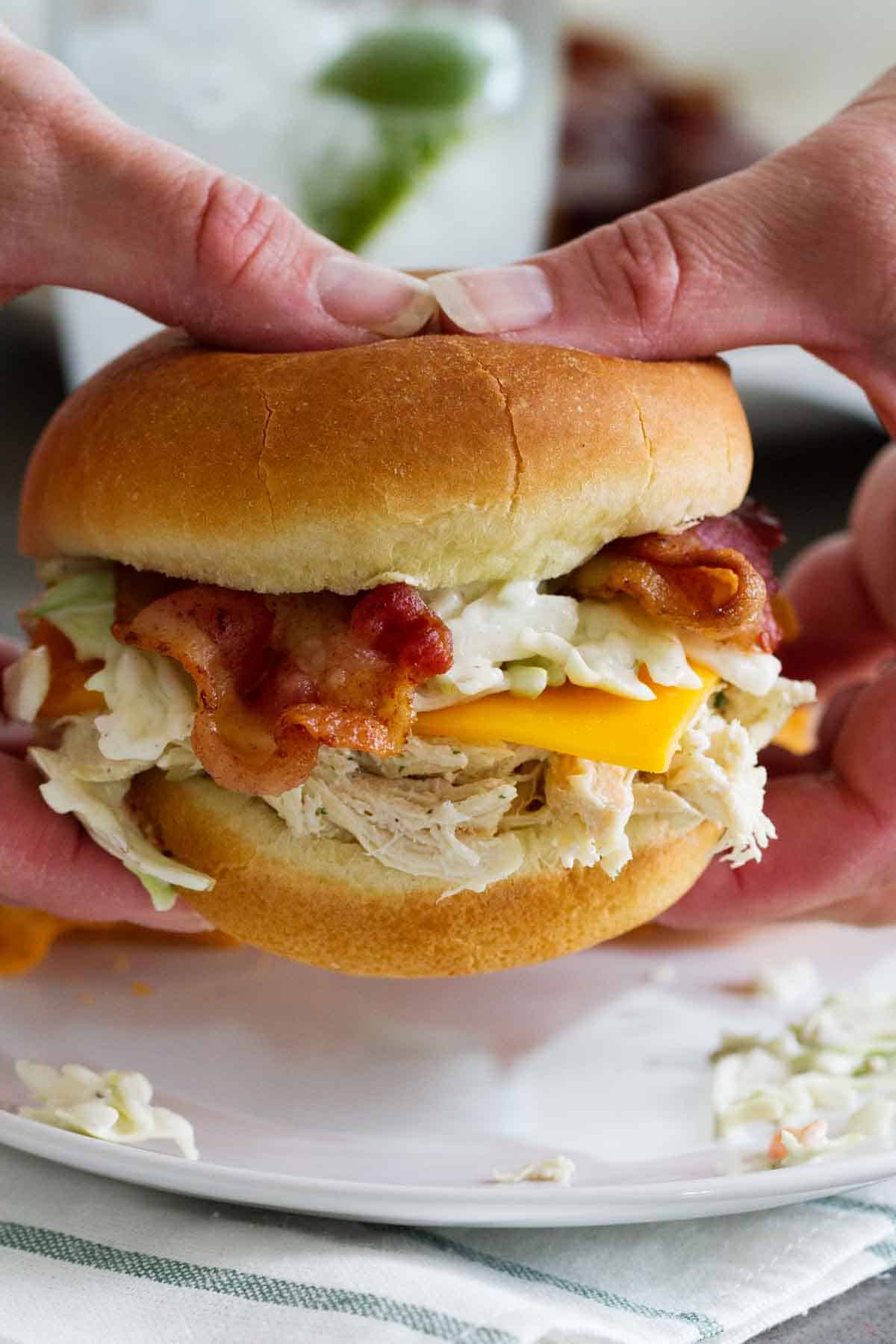 hands holding a ranch chicken sandwich with ranch slaw
