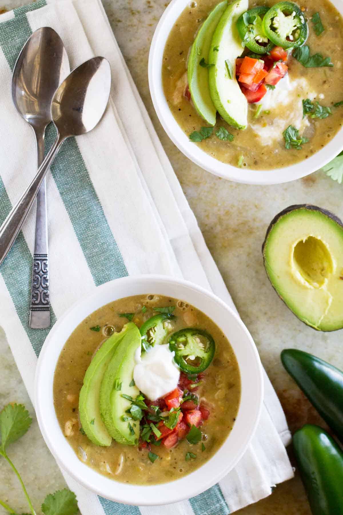 overhead view of bowls of white chicken chili with toppings