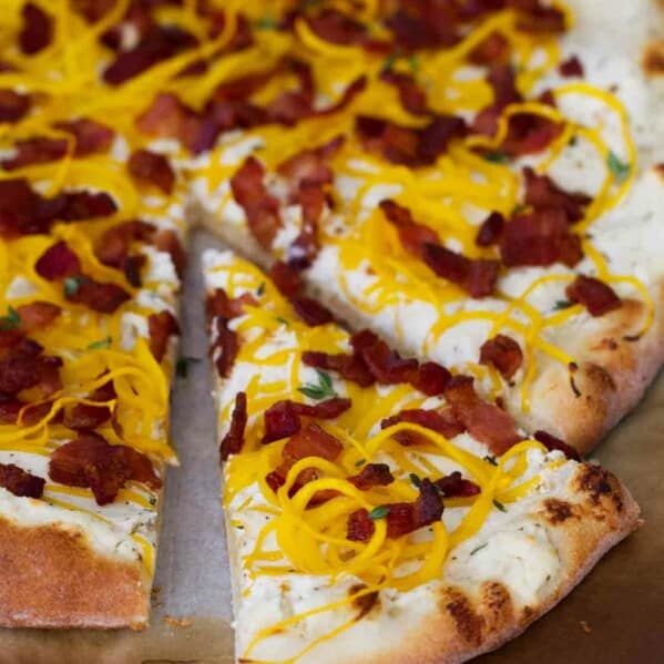Bacon and Spiralized Butternut Squash Pizza with a slice cut out.