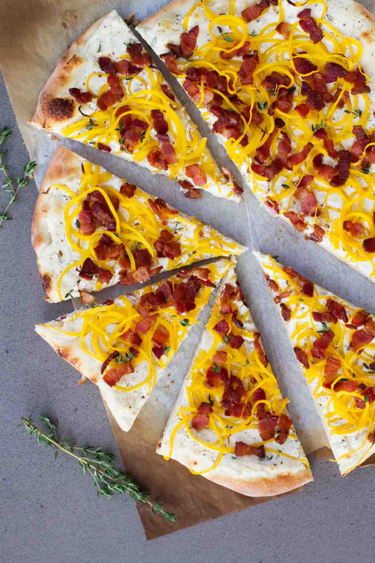 Celebrate fall with this Bacon and Spiralized Butternut Squash Pizza - creamy ricotta cheese is topped with spiralized butternut squash and crispy bacon for a pizza packed with fall flavors.