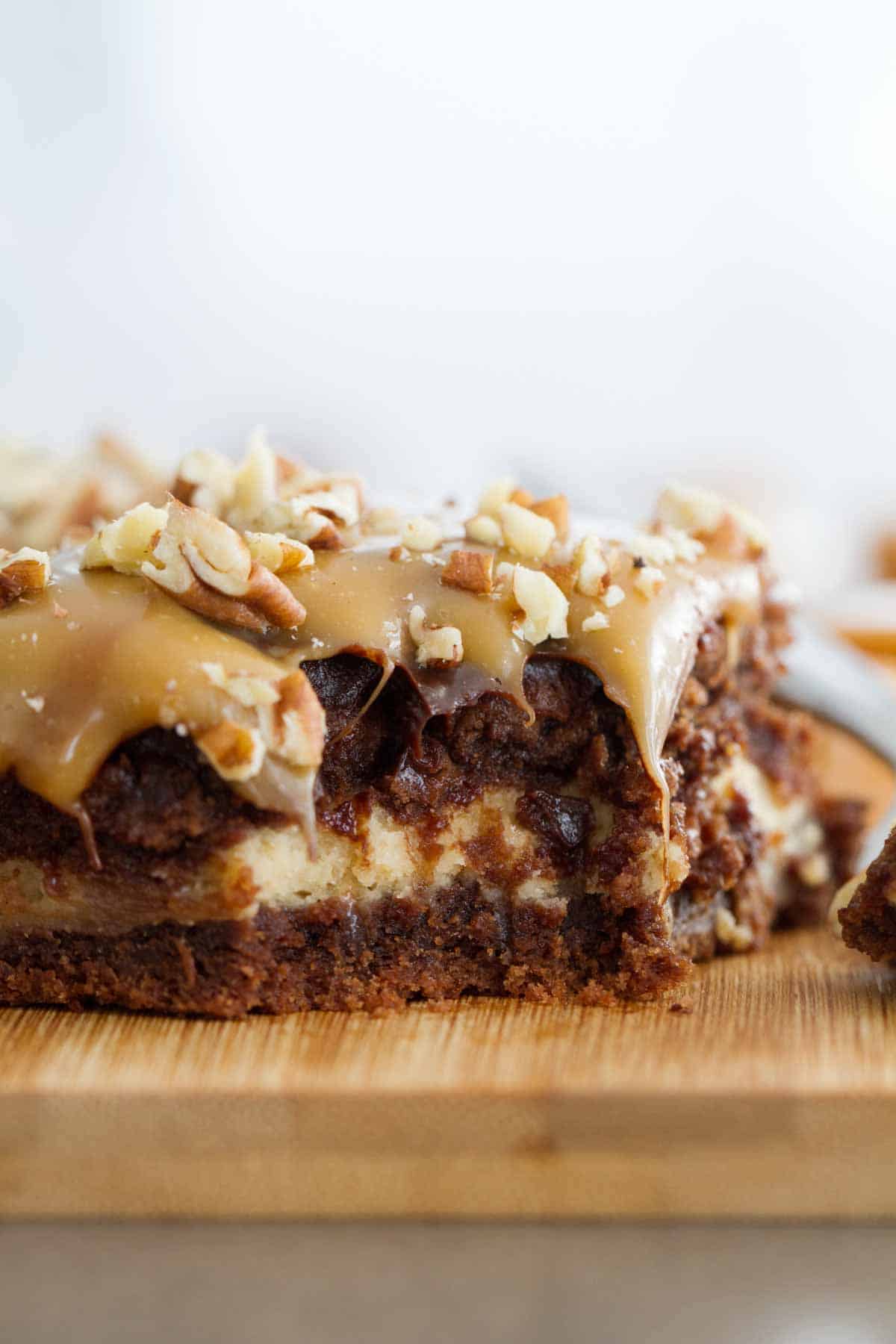 Turtle Cheesecake Cookie Bar showing the cheesecake layer in the middle.