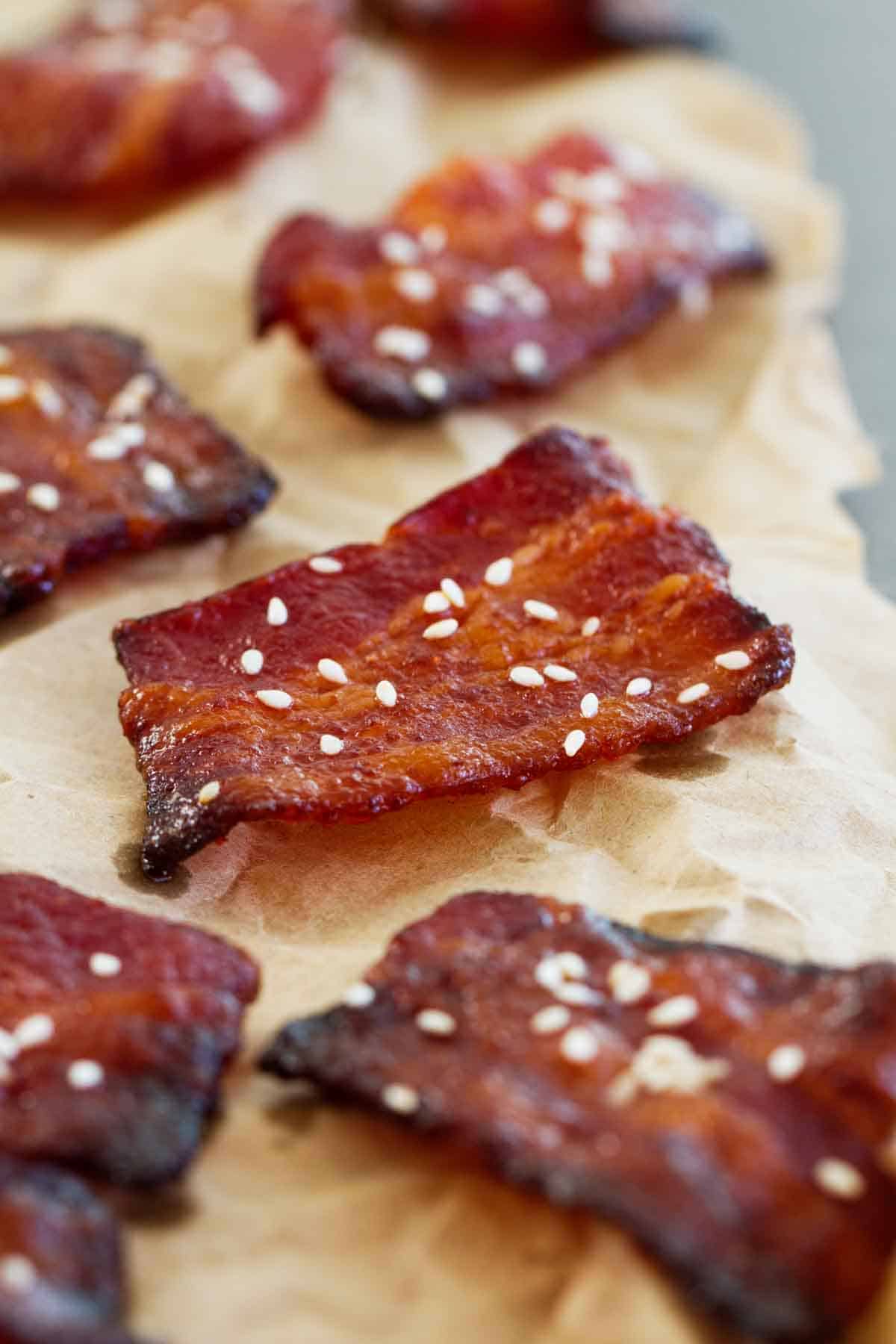 Brown Sugar Sriracha Bacon Bites topped with sesame seeds.