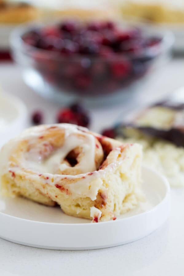 Light and fluffy and perfect for the holiday season, these Cranberry Cinnamon Rolls are filled with a cranberry filling and topped with a delicious and unique frosting.
