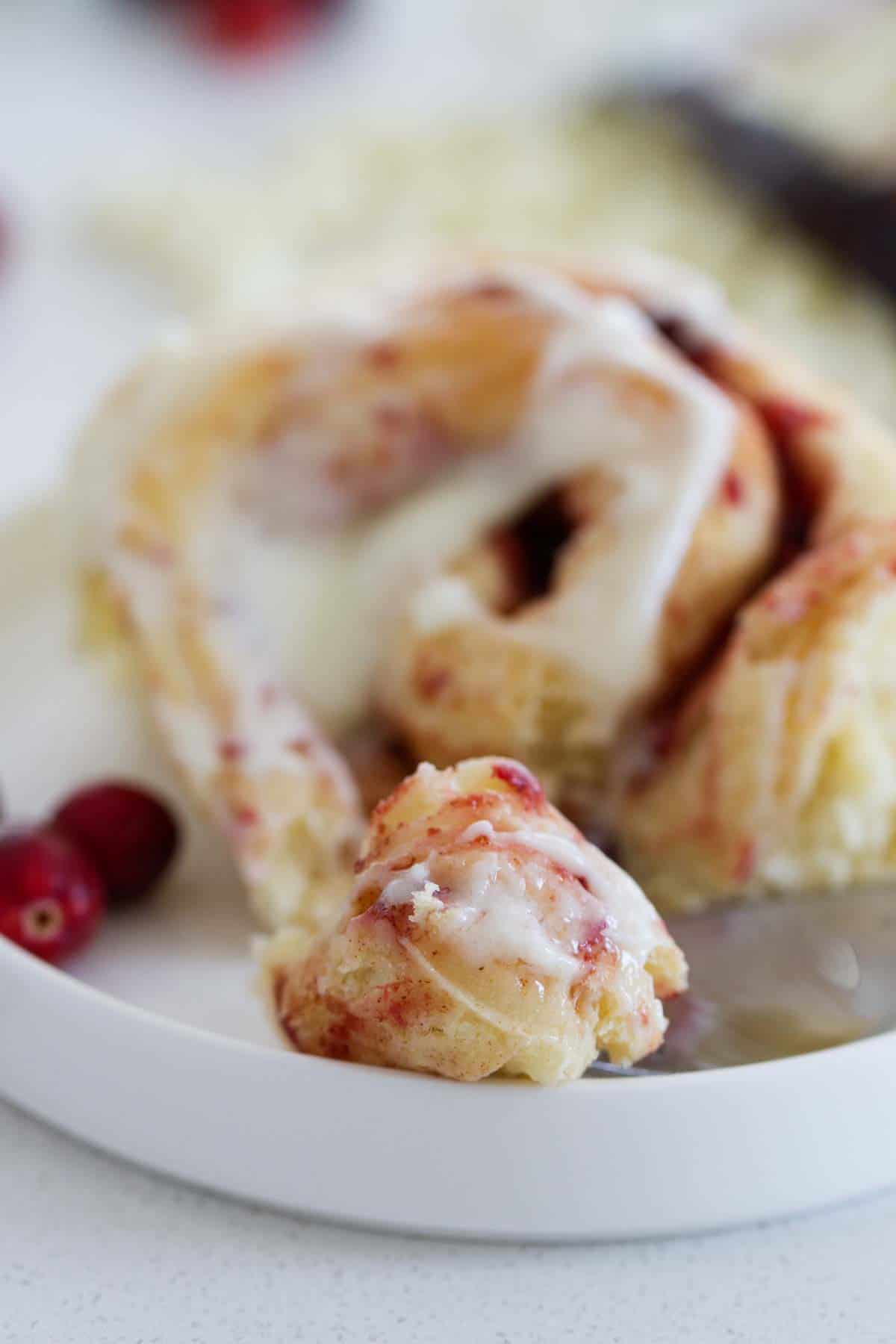 part of cranberry cinnamon roll pulled off to show interior