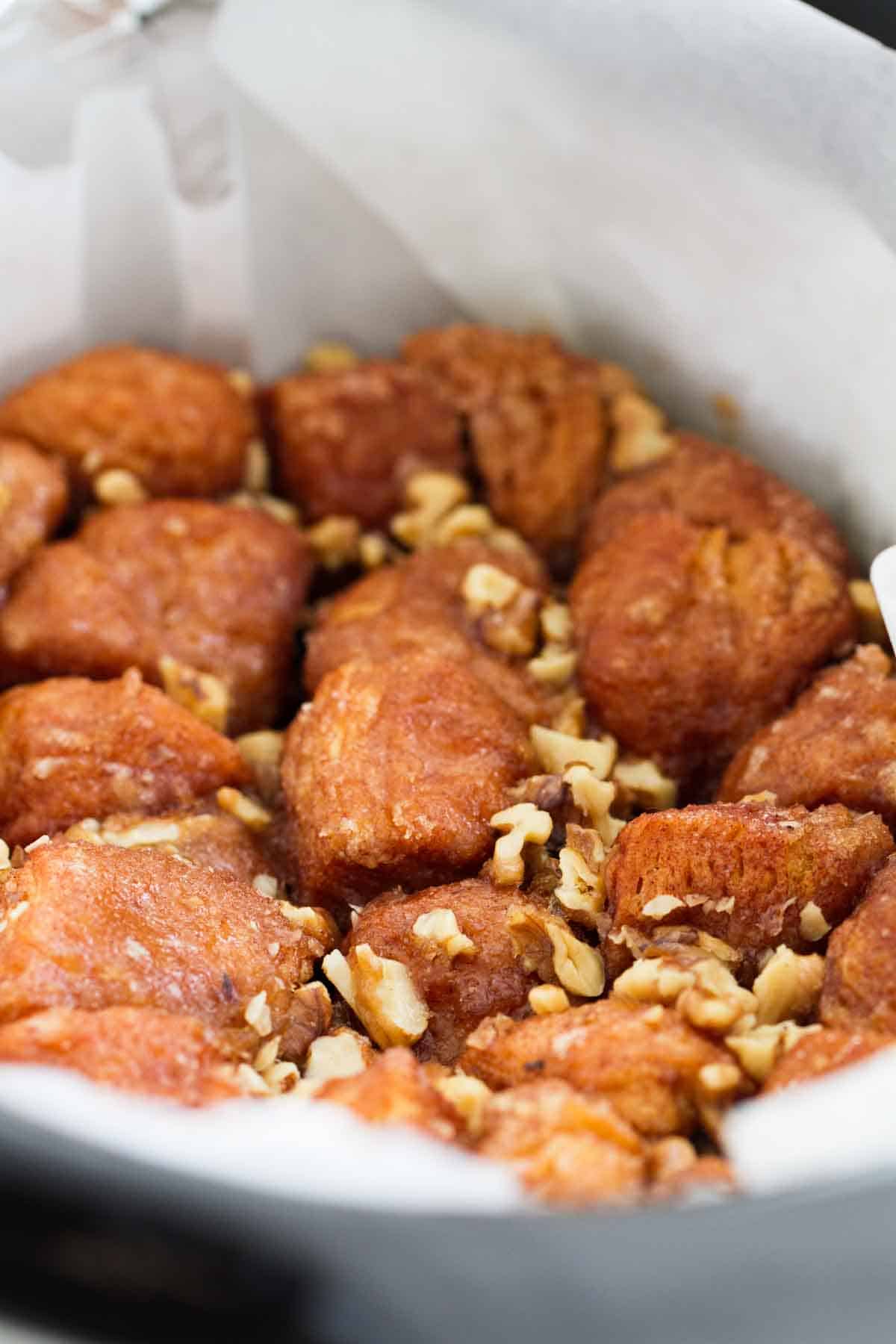 parchment paper lined slow cooker with monkey bread