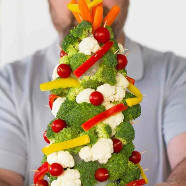 Man holding a Veggie Christmas Tree.