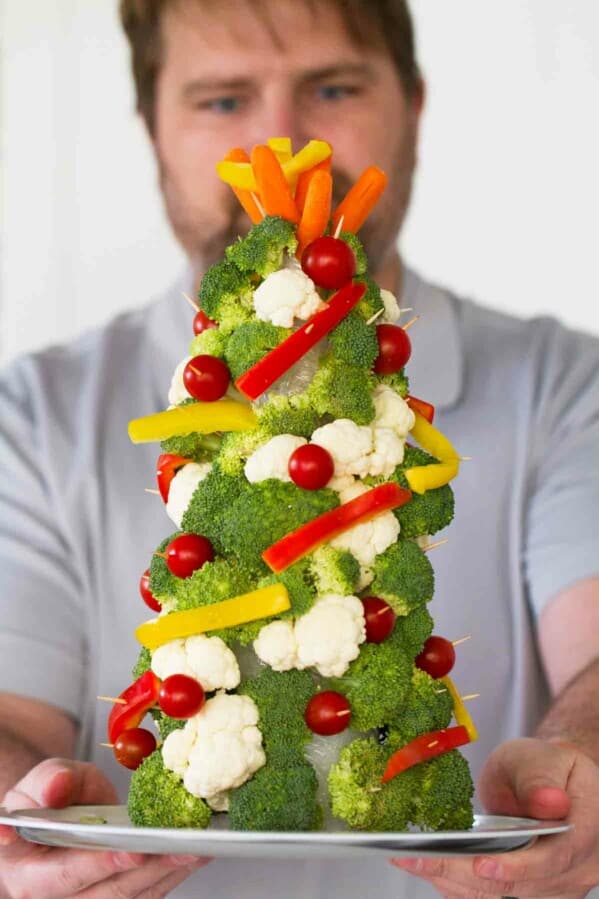 Man holding a Veggie Christmas Tree.