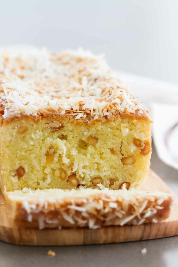Transport yourself to the tropics with this Kona Coconut Loaf! Sweet pineapple and nutty macadamia nuts make this loaf cake the perfect dessert for when you are wanting something tropical.
