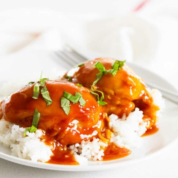 Instant Pot Honey Garlic Chicken over rice on a white plate.