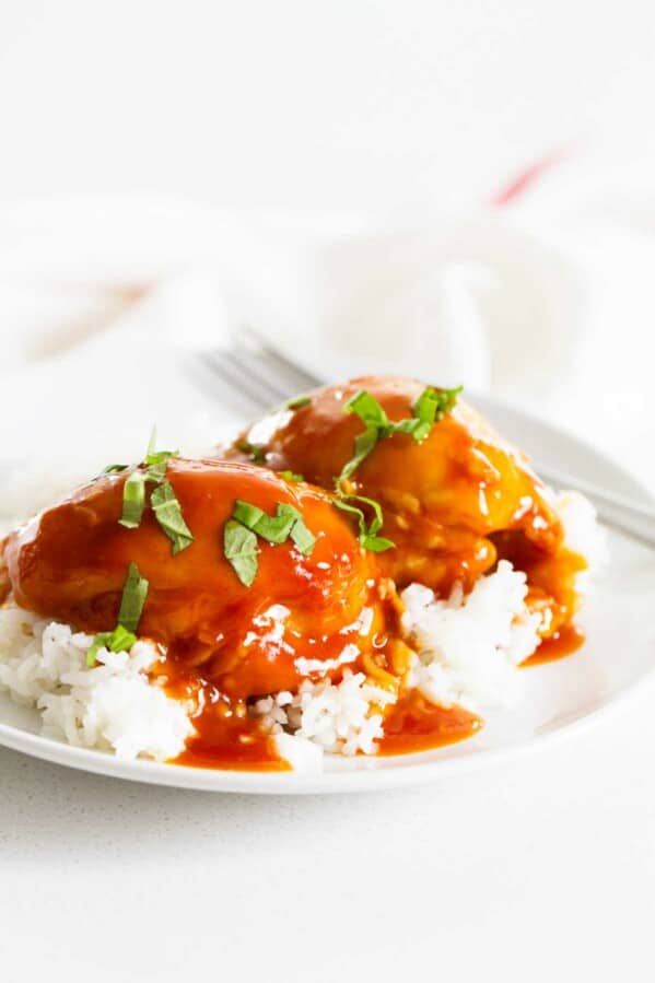 Instant Pot Honey Garlic Chicken over rice on a white plate.