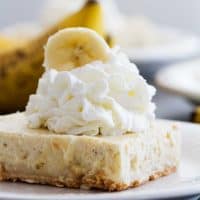 Banana Cheesecake Cookie Bar topped with whipped cream.
