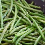 green beans with sesame seeds in a skillet