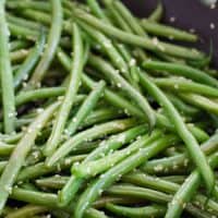 green beans with sesame seeds in a skillet