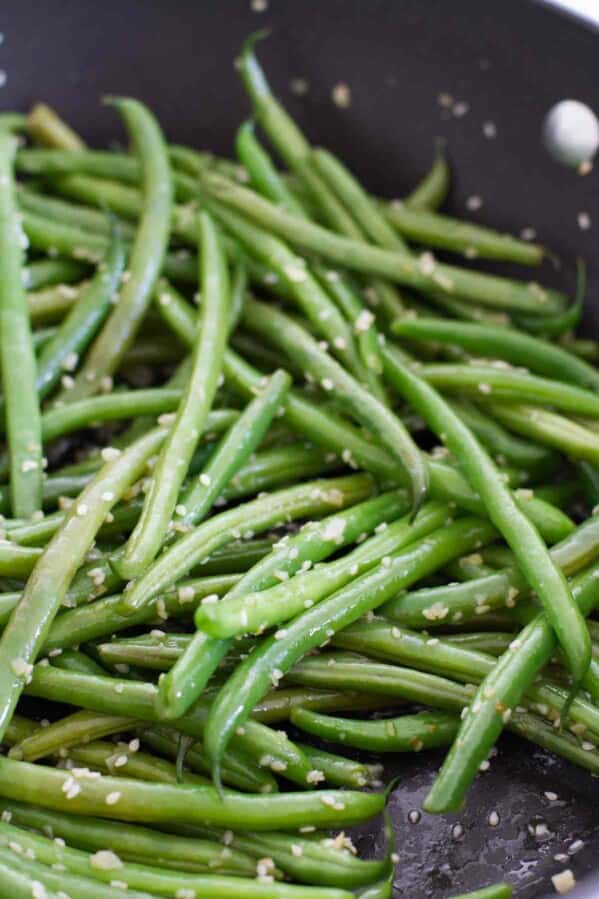 green beans with sesame seeds in a skillet