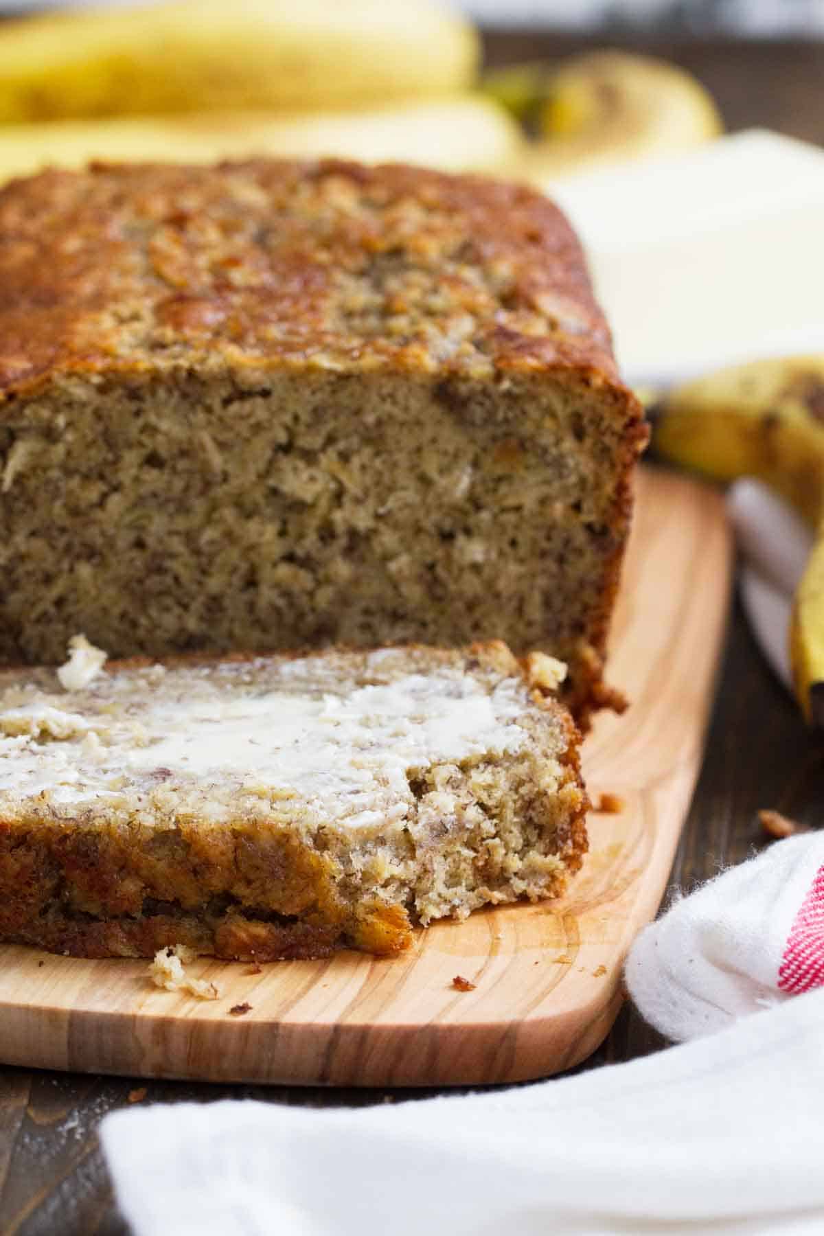 Slice of Banana Oat Bread with butter.