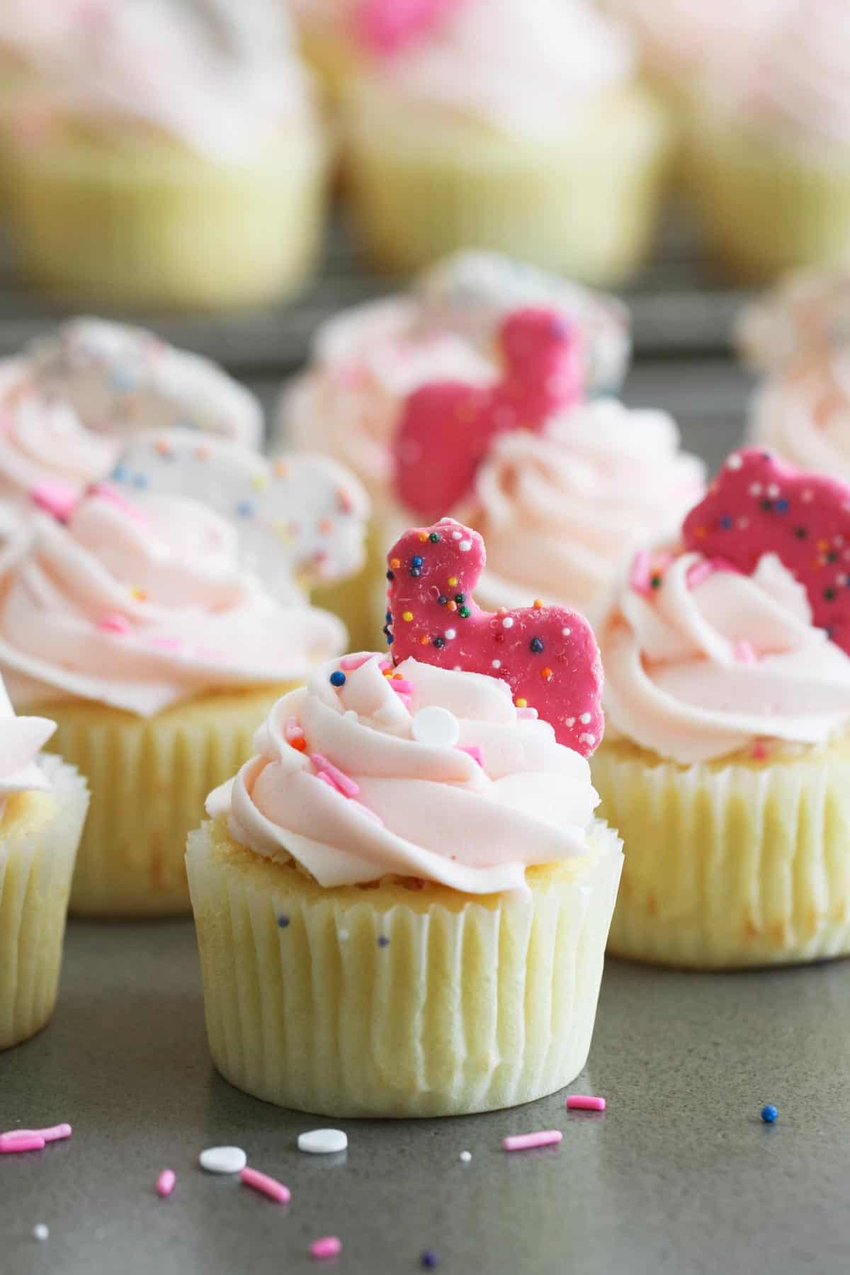 Circus Animal Cookie Cupcakes topped with cookies.