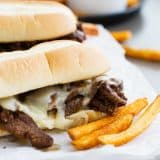 Spicy Cajun Cheesesteak Sandwiches with french fries on the side