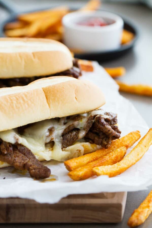 Spicy Cajun Cheesesteak Sandwiches with french fries on the side