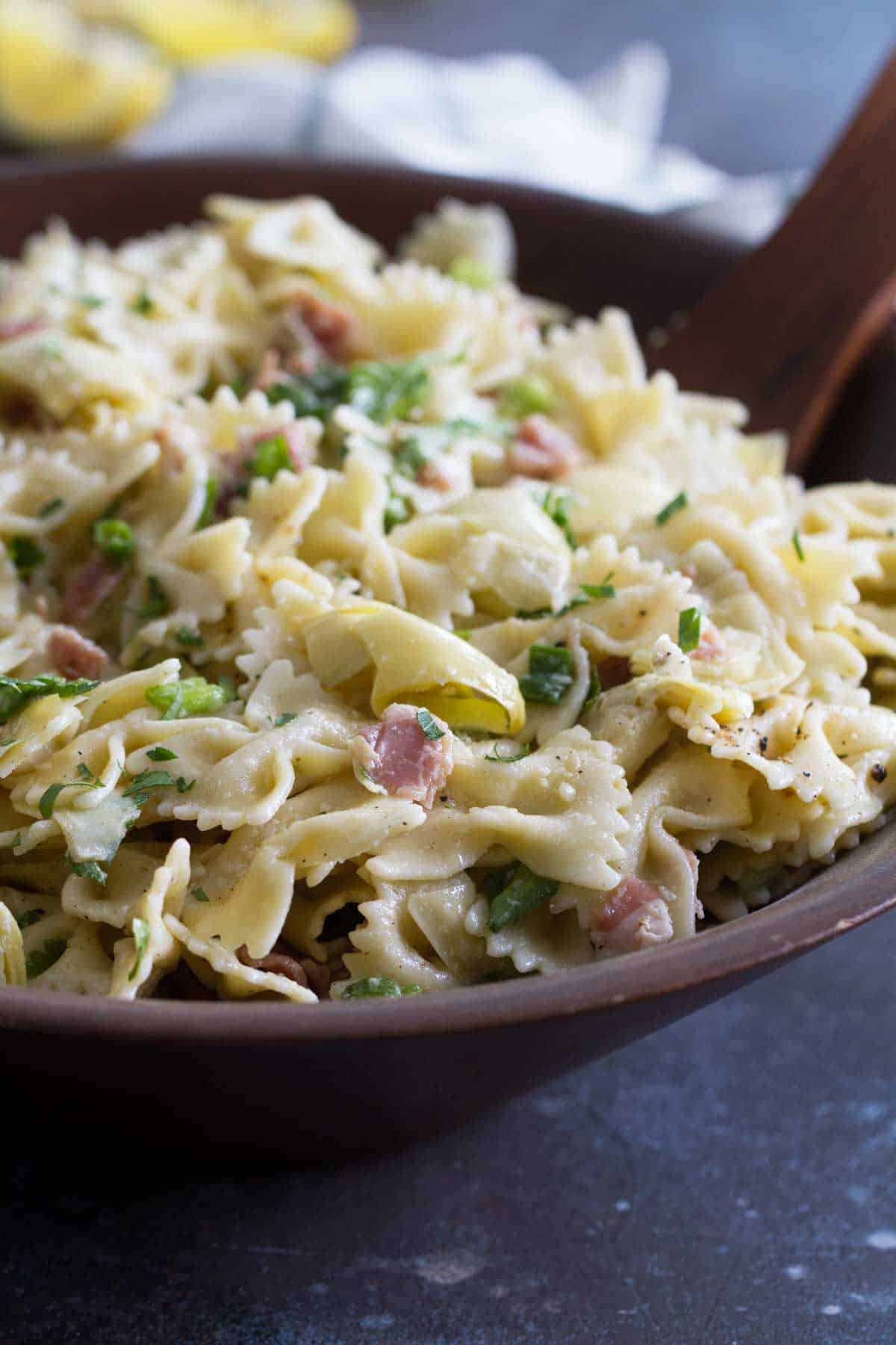 Artichoke pasta salad in a wooden bowl