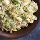 artichoke pasta salad with text bar at the bottom