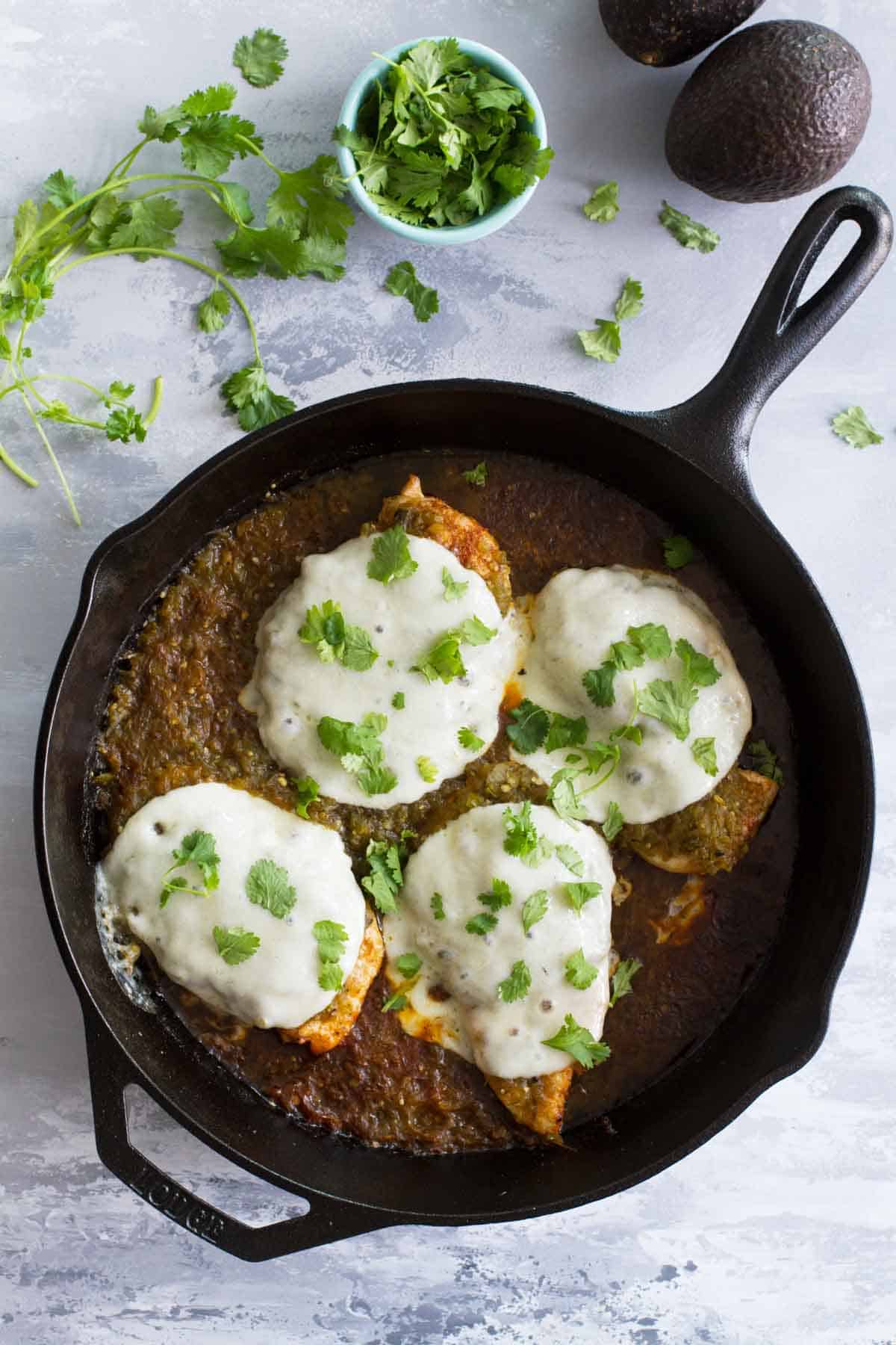 Salsa Verde Chicken in a cast iron skillet.