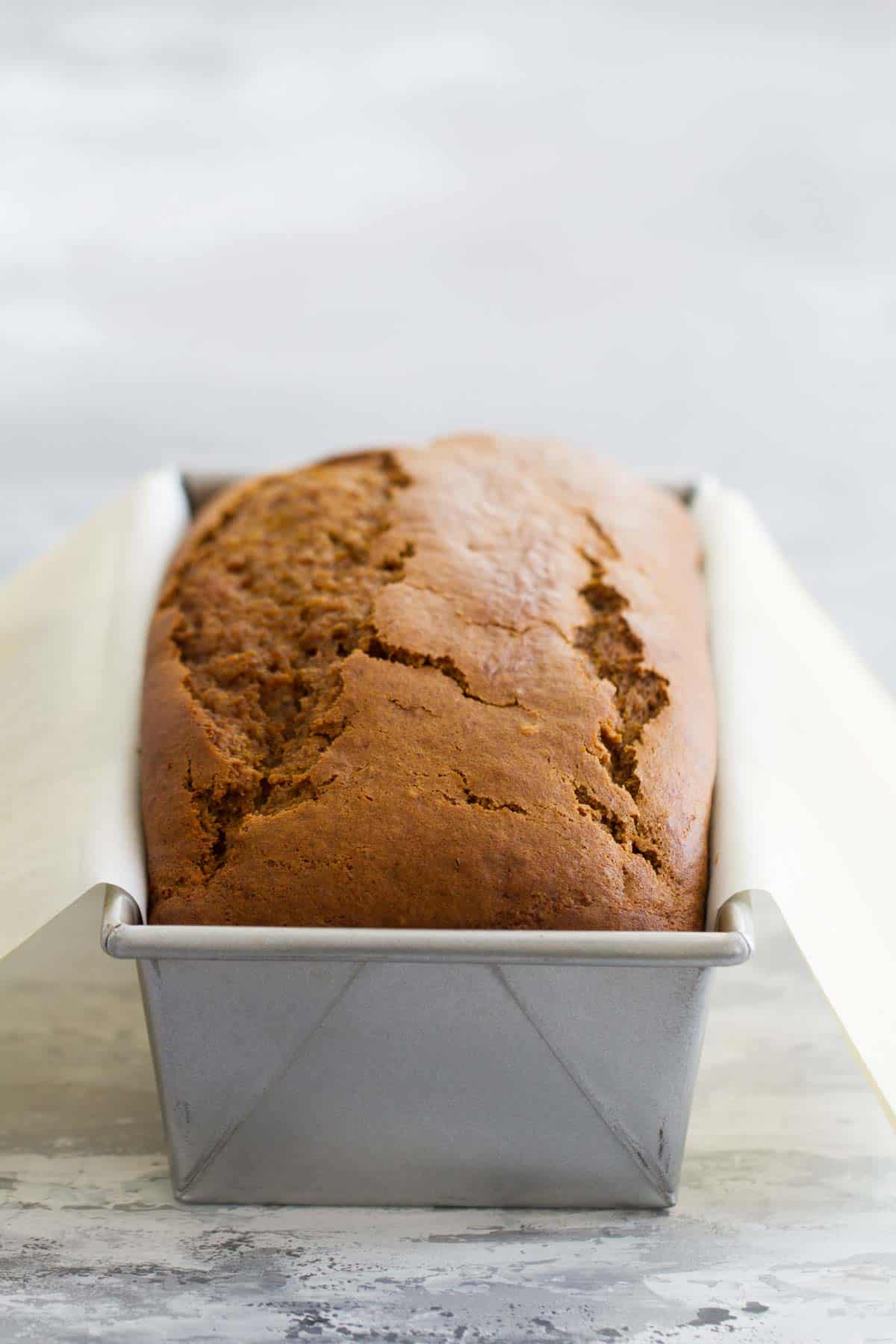 Loaf of homemade Pumpkin Bread with Cream Cheese Filling in a loaf pan.