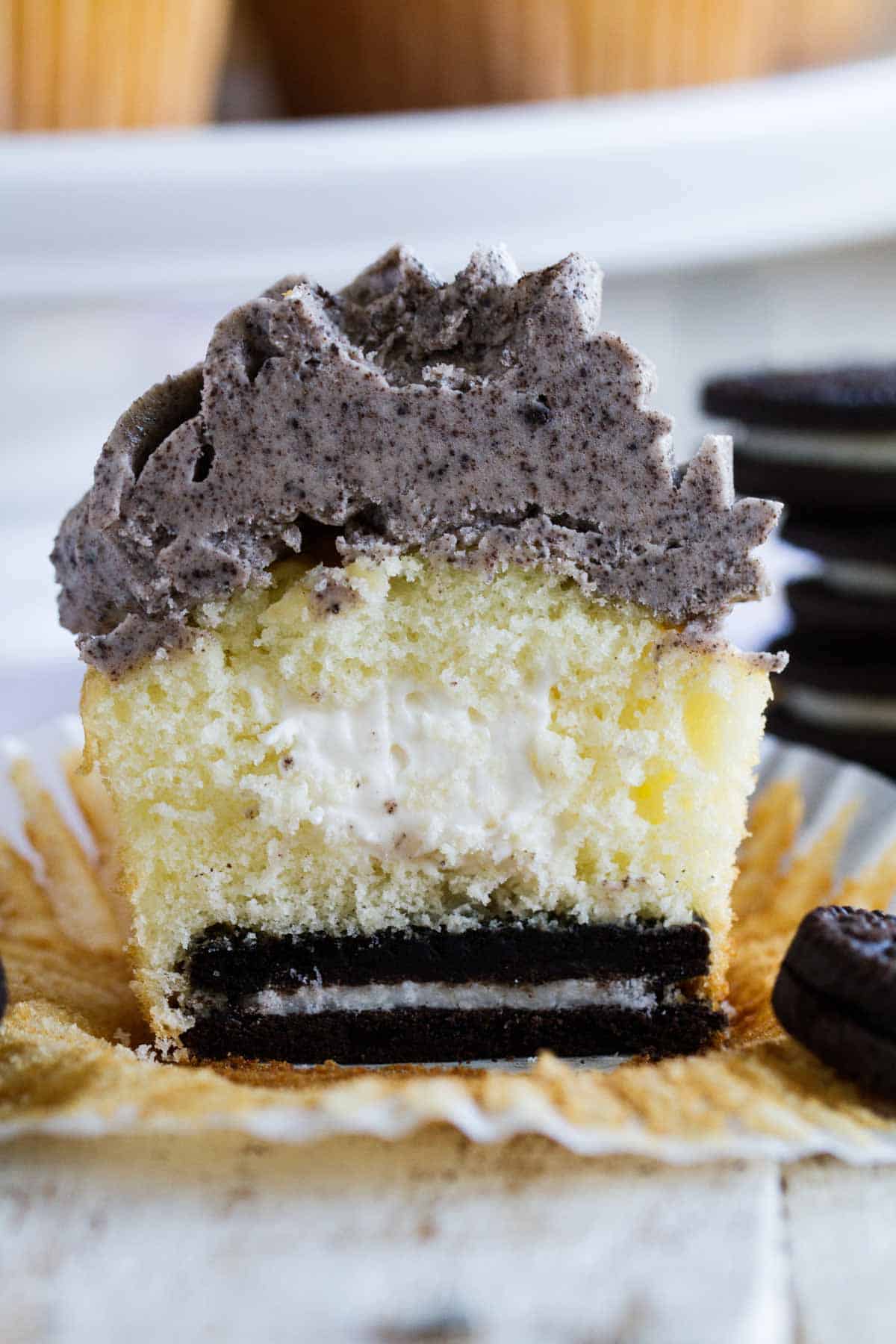 Oreo Cupcake Recipe - marshmallow filled cupcake with Oreo Buttercream Frosting with an Oreo on the bottom.