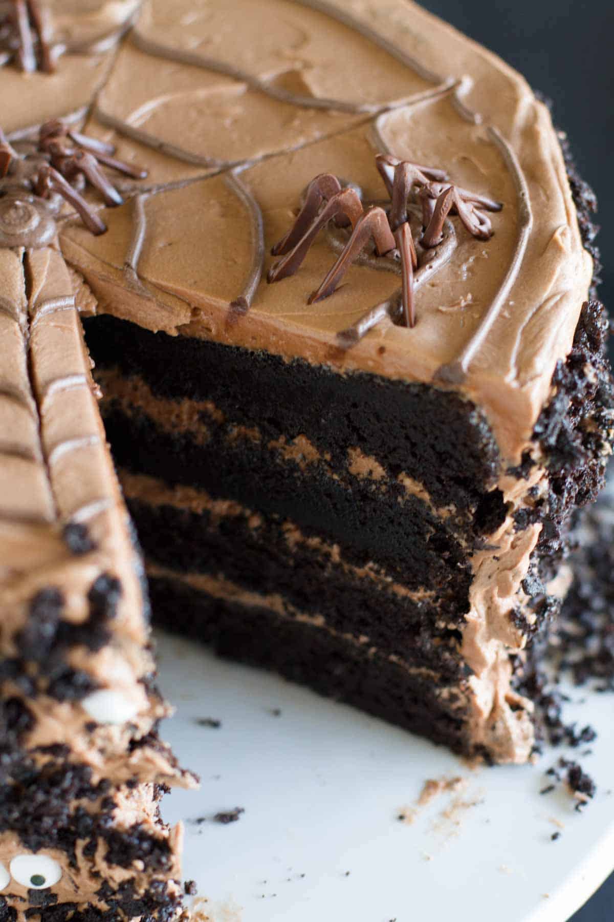 Dark Chocolate Cake with Nutella Buttercream with a slice taken from the cake.