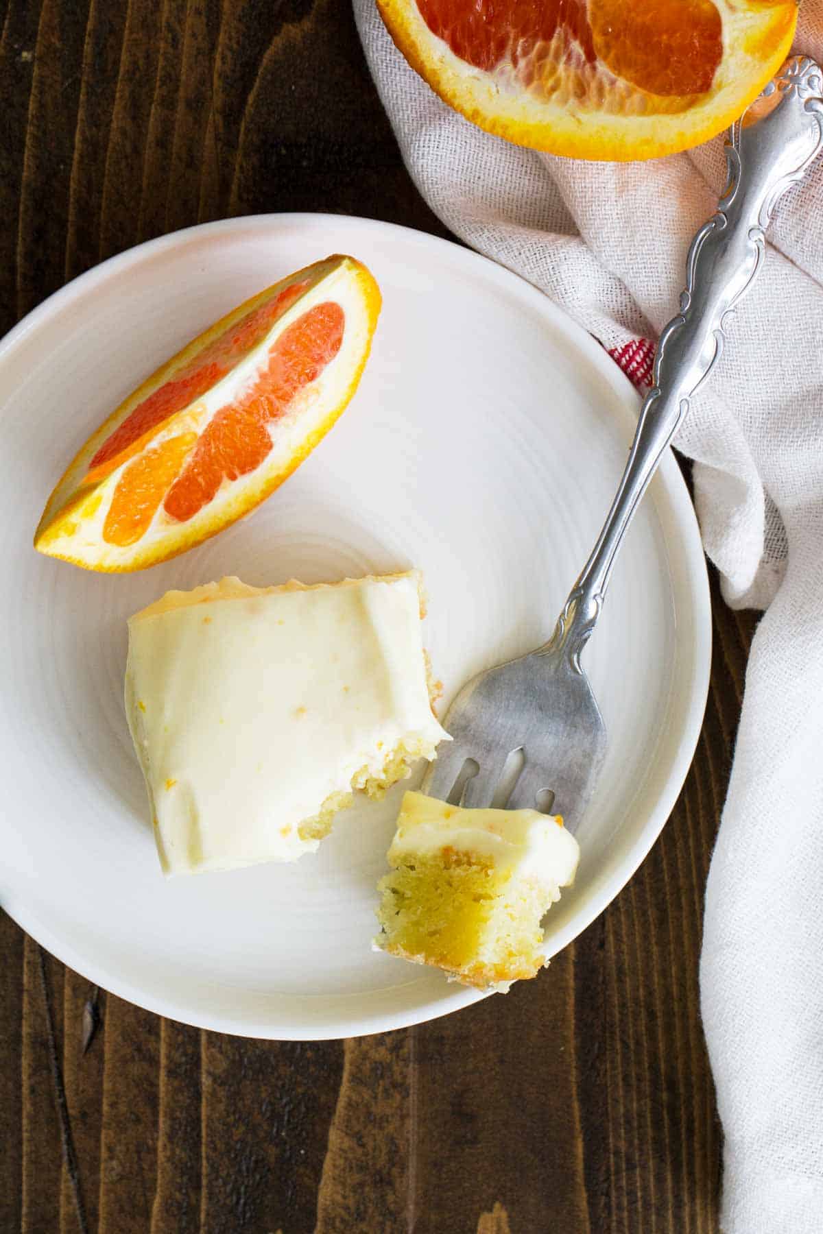 Orange Brownie on a plate with a slice of orange